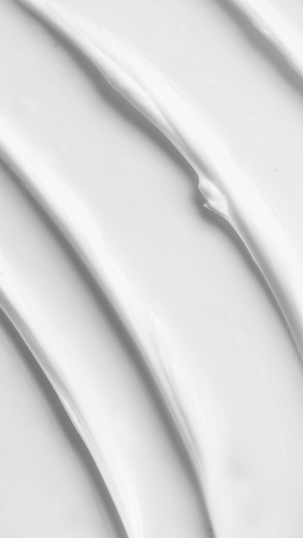 A close-up vertical shot of thick, creamy white product, likely the Celestial Moisturiser, showing several textured, undulating waves and ridges.